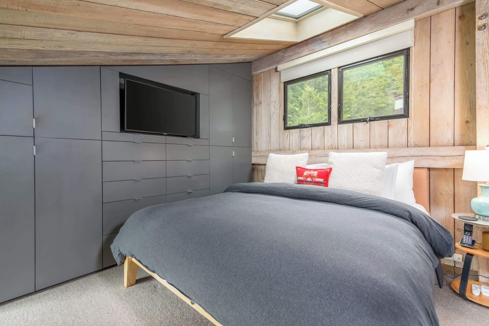 Loft style bedroom with Queen bed, and TV