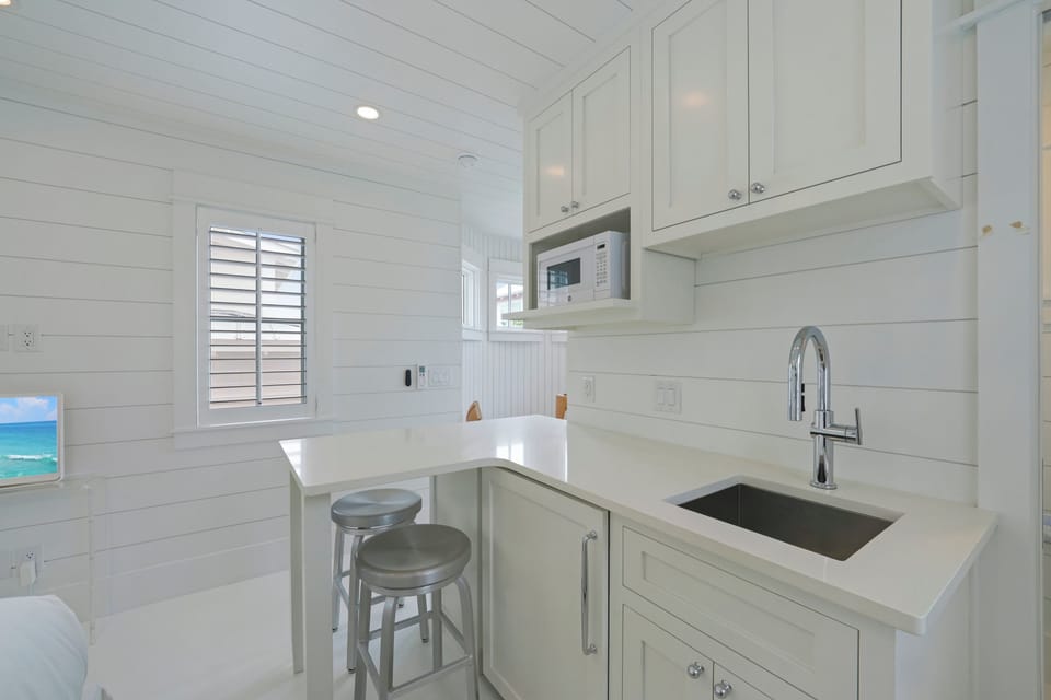 KITCHENETTE AND BAR SEATING FOR TWO ON SECOND STORY
