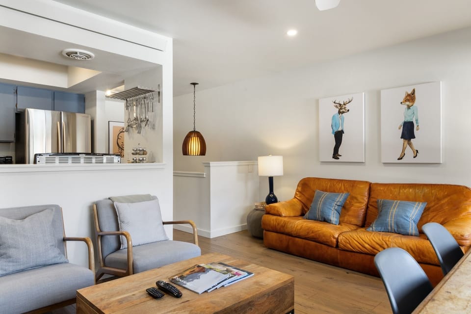Unwind in your stylish living space featuring plush leather seating and whimsical artwork that adds character to your stay.