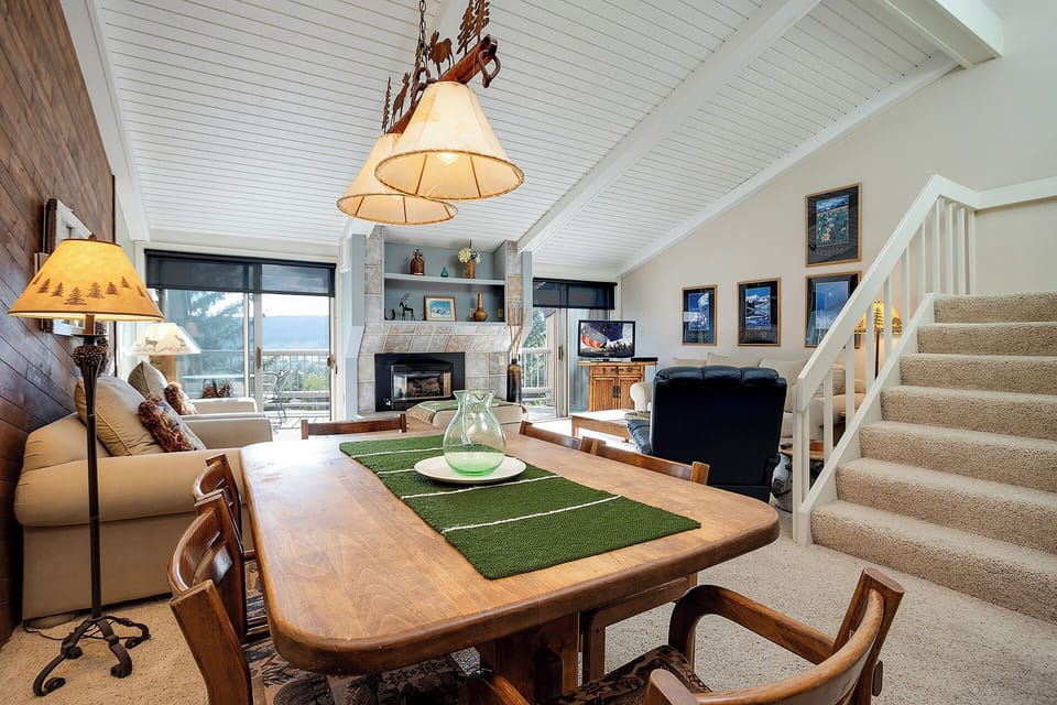 Relax in your cozy living space with vaulted ceilings, warm fireplace, and comfortable seating perfect for unwinding after mountain adventures.