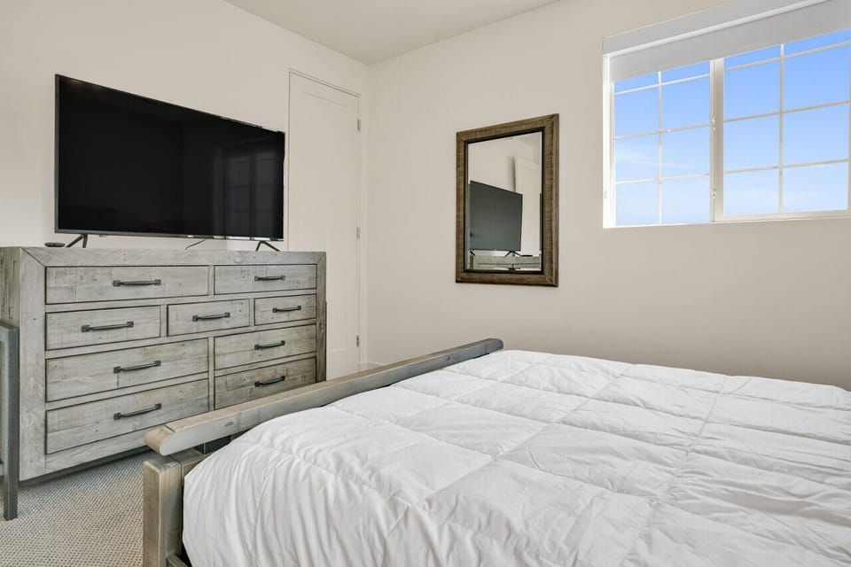 A large TV and cabinet in bedroom 3