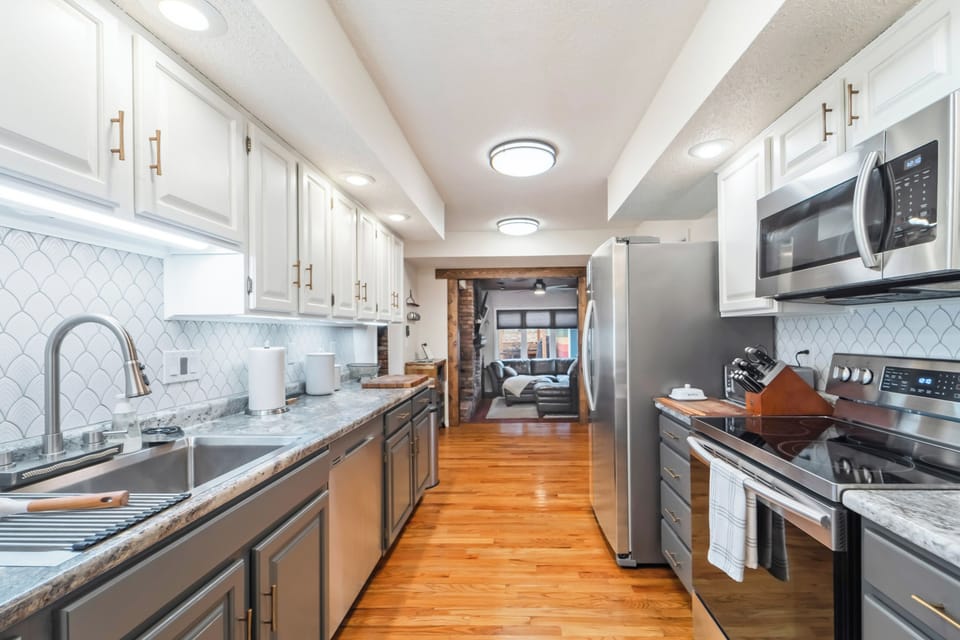 The kitchen is fully stocked with all baking essentials including a rice cooker, waffle maker, vitamix, pizza pan, baking sheets, Instapot, popcorn maker, and lots of mixing bowls.