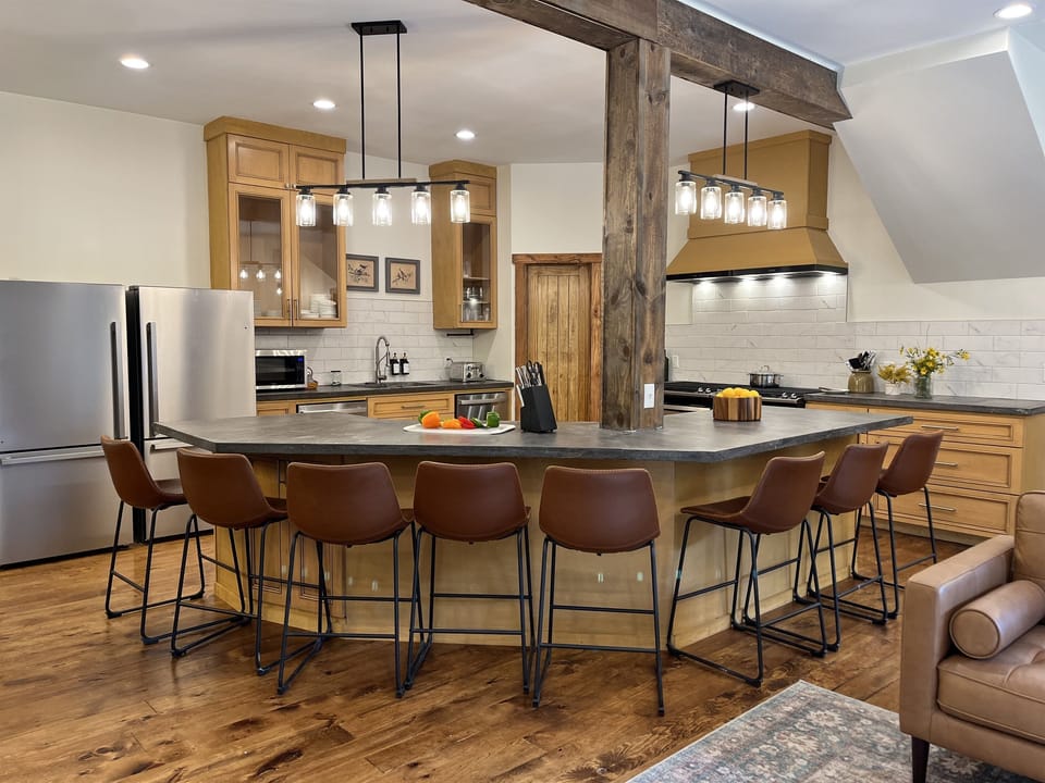 A kitchen built for togetherness! Featuring an oversized 8-seat island, double ovens, two refrigerators, and two dishwashers to make group meals and cleanup effortless