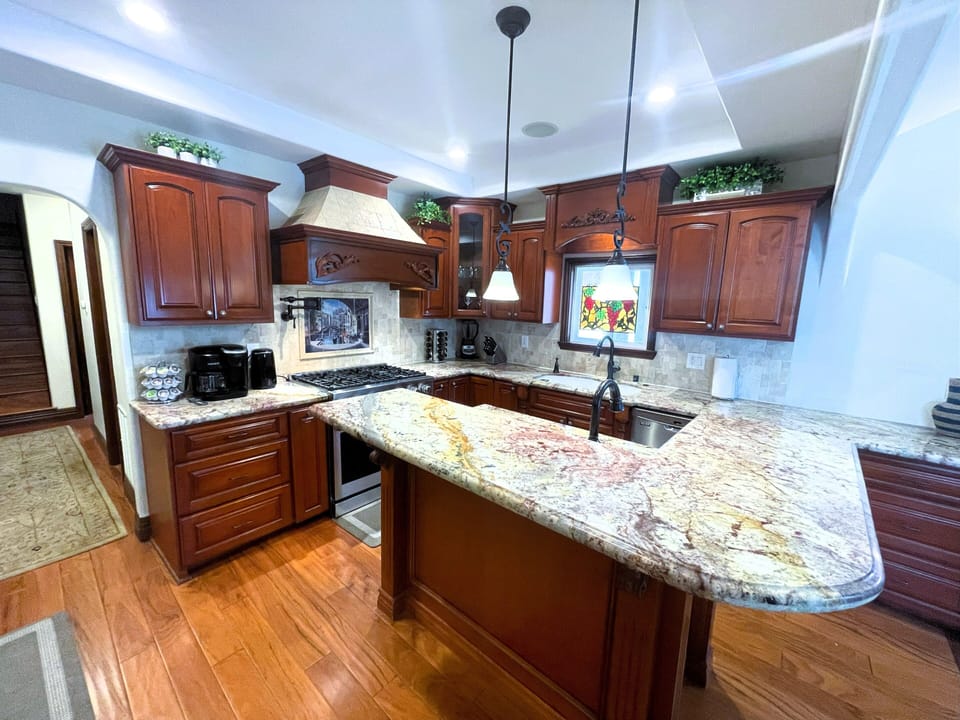 Spacious, well stocked kitchen with seating for 2 at the counter.