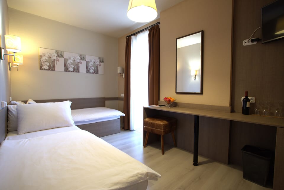 Family Triple Room, Balcony, Partial Lake View | In-room safe, blackout drapes, soundproofing, iron/ironing board