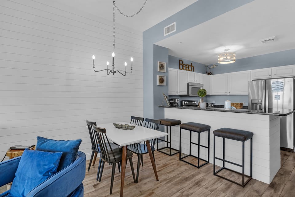 Dining Area - Dine in comfort and style at this elegant table for four, set against a beautiful backdrop of the beach and endless ocean horizons. Includes 3 bar stools for extra seating!