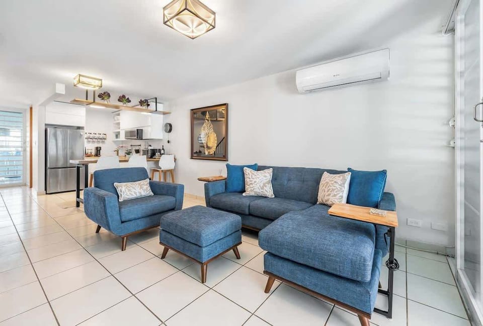 This living room blends relaxation with productivity. It offers a dedicated workspace within the comfort of your home. Deep-cushion, upholstered sectional couch w/matching armchair and footstool.
