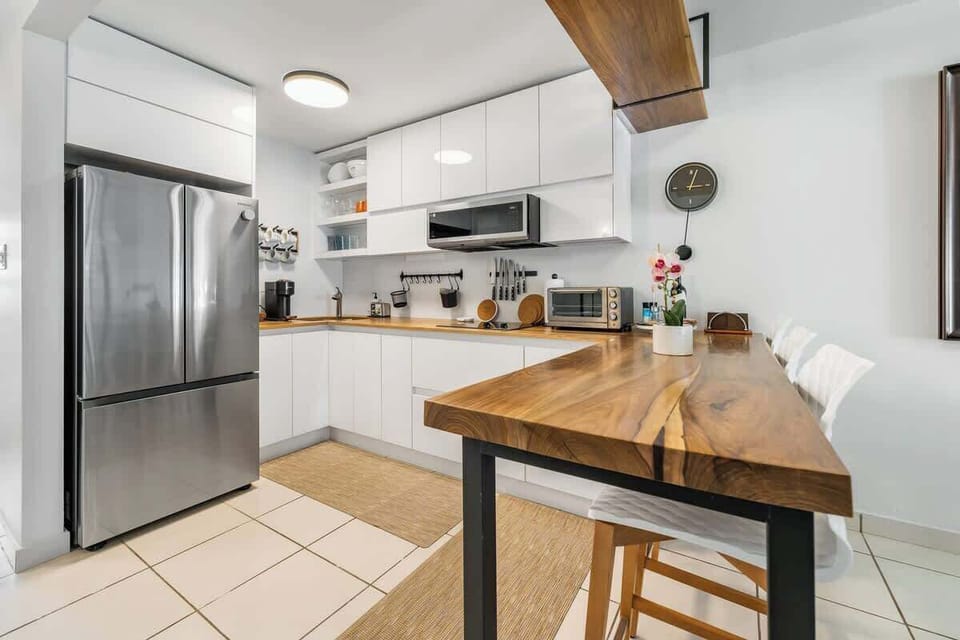 White Cabinetry Finishing
 Rich natural-wood countertops
 Ceiling-mounted “Floating Shelf”
 Coffee Maker
 Triple-door refrigerator
 Flush-top stove range
 Microwave Oven
 Toaster Oven
 Service counter with three barstools