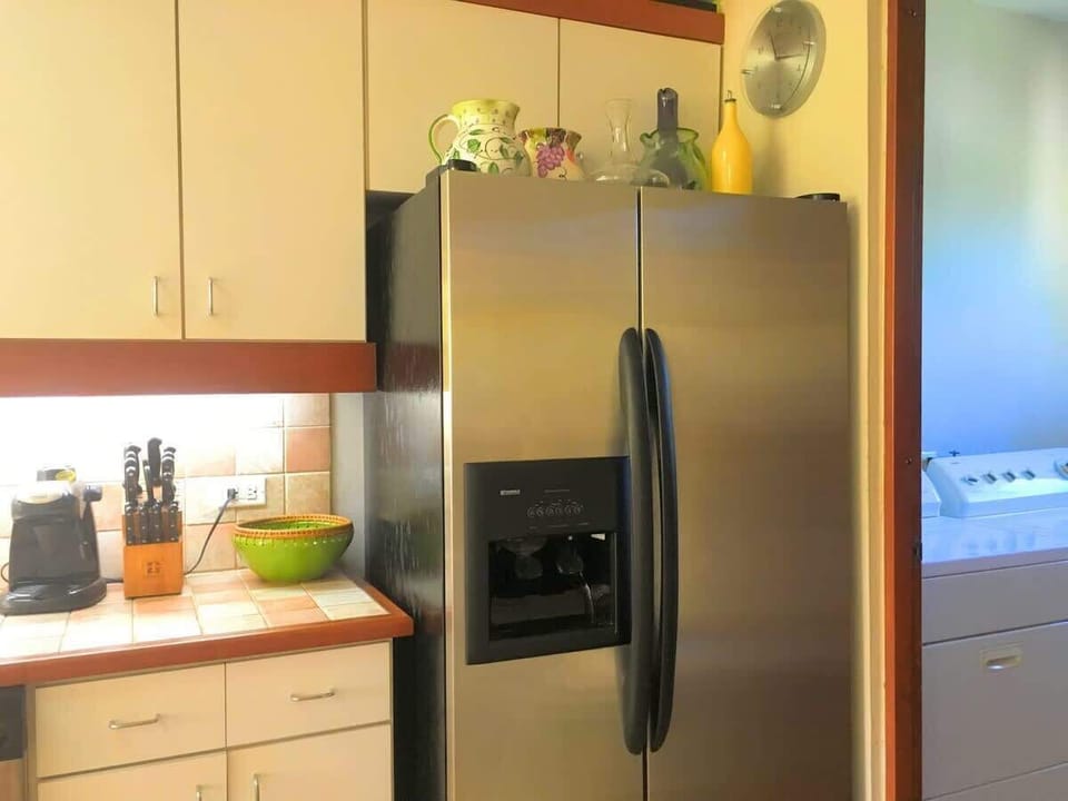 Fully equipped kitchen
2-stool bar seating
Dishwasher
Double-door refrigerator with ice-maker
Flush-top induction stove on center, tiled island
Blender, Coffeemaker, and Toaster Oven
Microwave Oven
White flush cabinetry