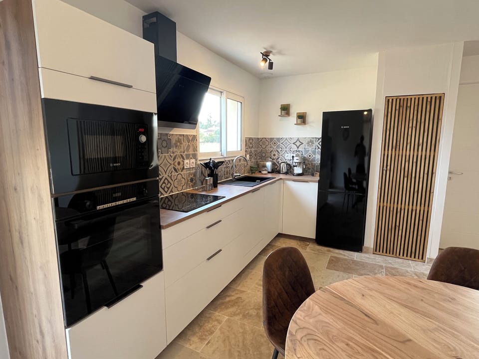 The modern kitchen is well equipped with good quality appliances including a Delonghi expresso maker