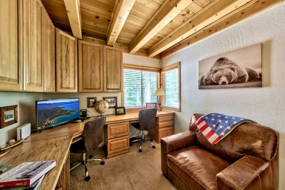 Office space with two desks and a monitor.