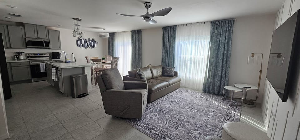 living room with long leather coach and recliner chair 