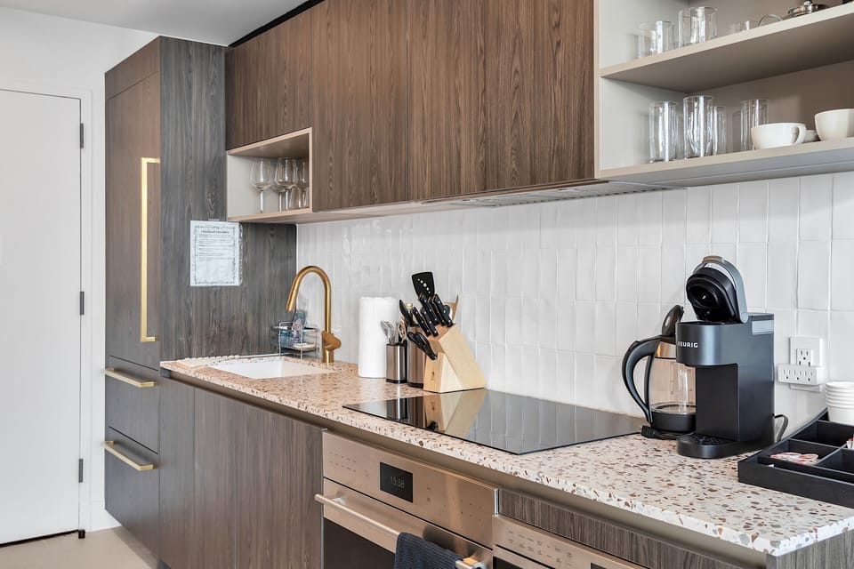Full kitchen, induction cooktop, stove, microwave, dishwasher.