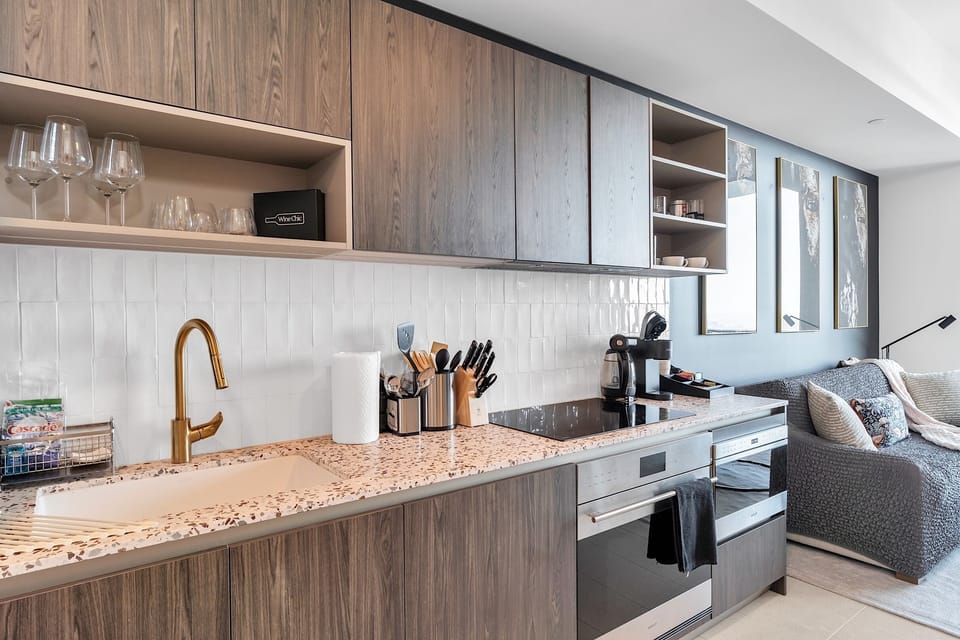 Full kitchen, induction cooktop, stove, microwave, dishwasher.