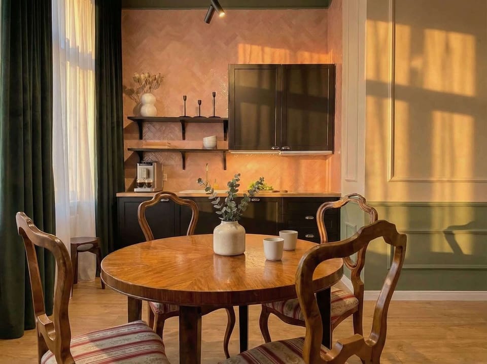 The first room has a kitchen, dinning table and queen size bed
