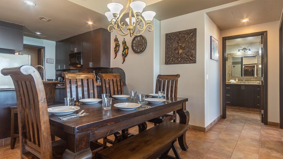 The unique sleigh design on the dining table for six, bathroom beyond.