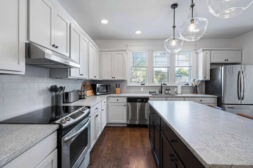 Craft delicious meals with ease in our fully-equipped kitchen, featuring a welcoming island bar perfect for both meal preparation and casual dining experiences.
