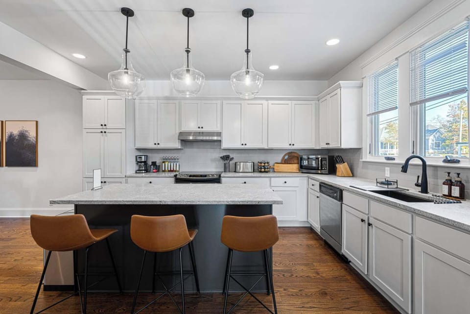 Spacious kitchen featuring a large island with seating, perfect for casual meals and gathering while cooking.