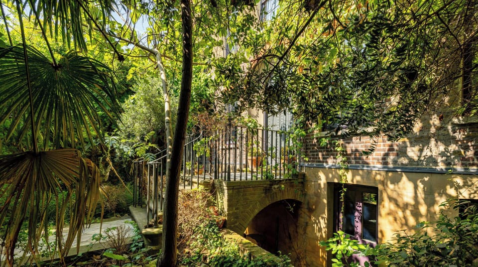 Malplaquet House charming brick facade surrounded by lush greenery