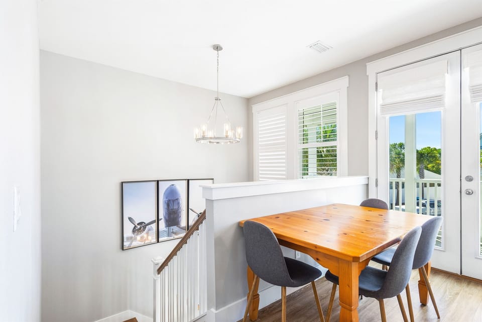 Gather around your stylish dining table where natural light streams through plantation shutters, creating the perfect spot for memorable meals together.