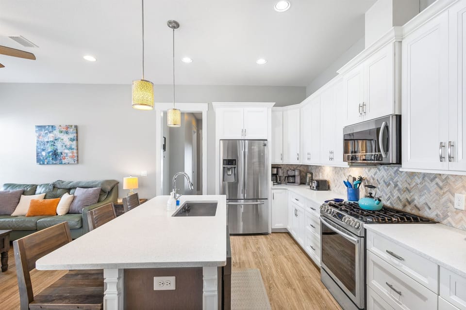 Your fully equipped chef's kitchen features stainless steel appliances, quartz countertops, and a stylish island perfect for meal prep.