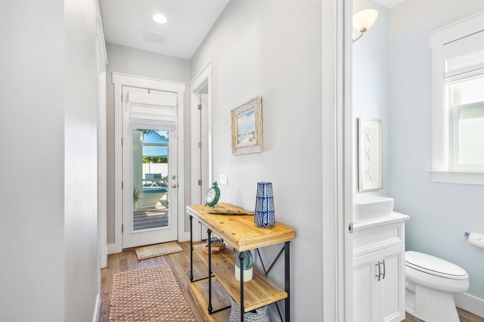 Step into your bright, coastal-inspired entryway where ocean views greet you through elegant French doors.