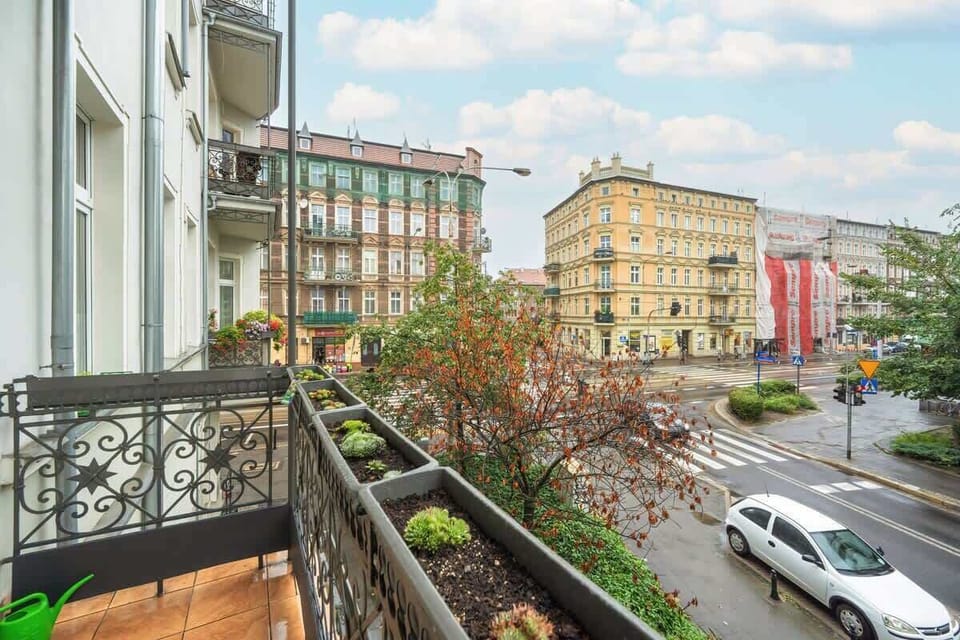  A balcony overlooking a quiet street with cozy furniture is ideal for tranquil mornings.