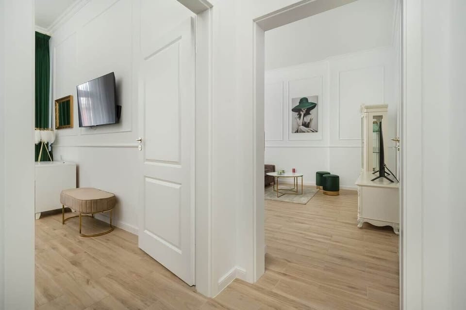The living room with a TV, designer decor, and soft tones invites you to unwind.