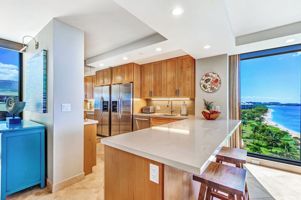 Share stories or sunset bites at the cozy kitchen bar for two inside Mahana 1119.