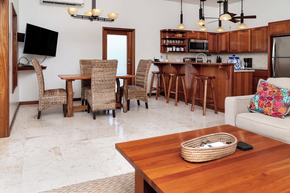 Dining area with seating for 4 at the table and 4 at the kitchen counter