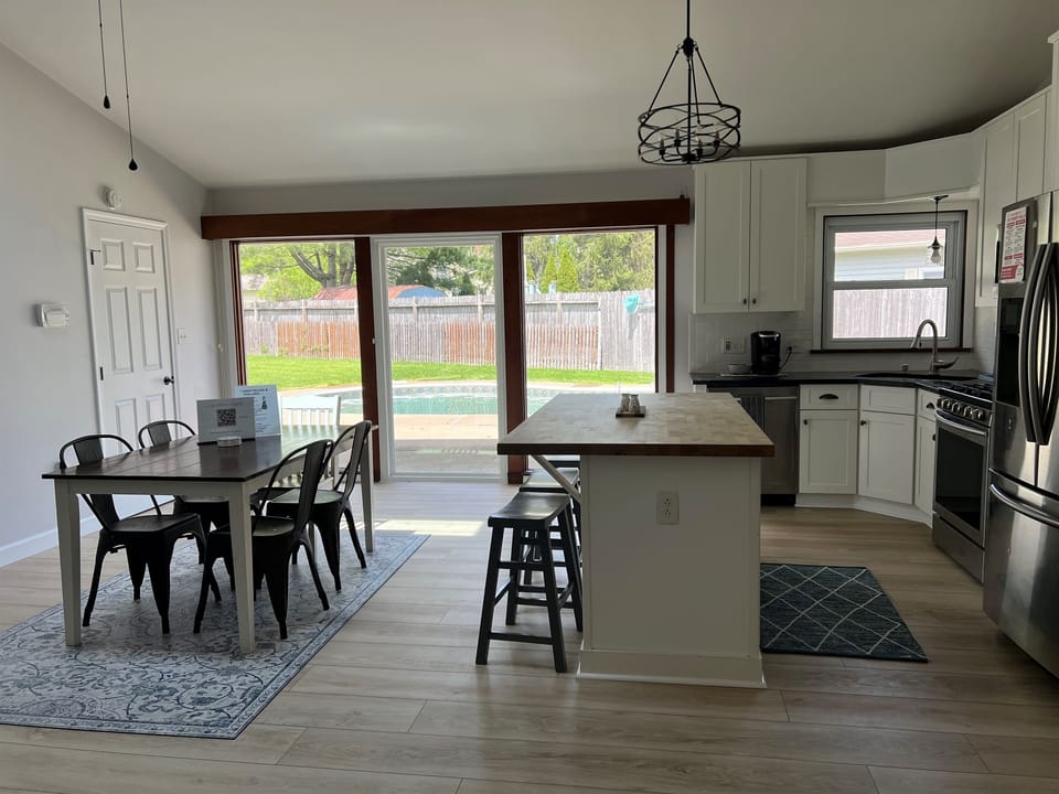 Bright, open kitchen and dining space with sliding doors leading straight to the pool and backyard.