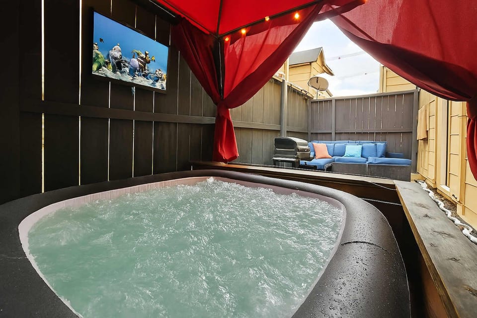 Private cabana retreat with sparkling hot tub and cozy lounge.