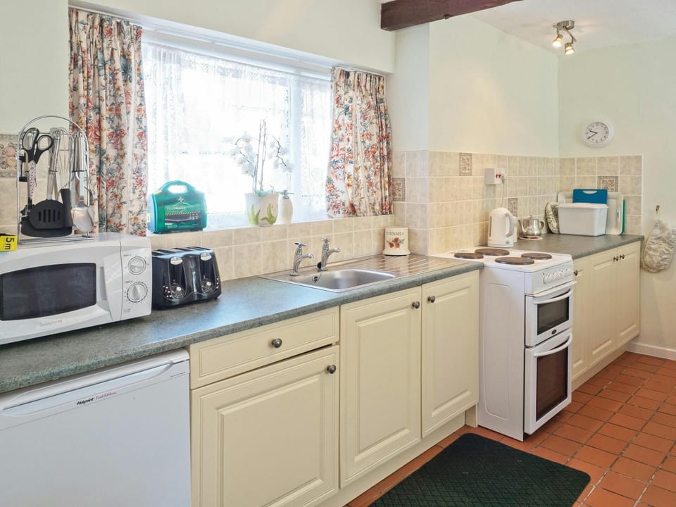 Base cupboards with electric cooker and under counter fridge