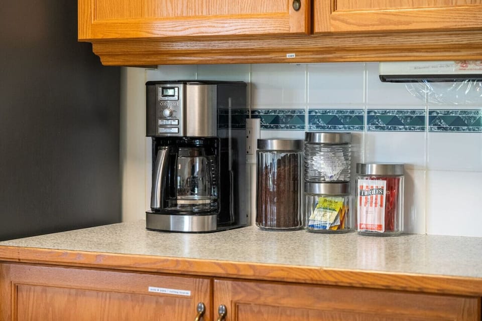 Full kitchen complete with a drip coffee maker, blender waffle maker, mixer & more.