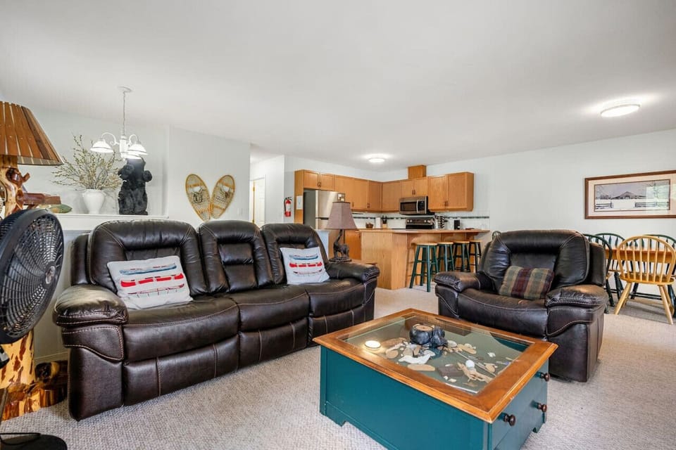 Main living room on the second level of the home with a TV, board games & access to the patio.