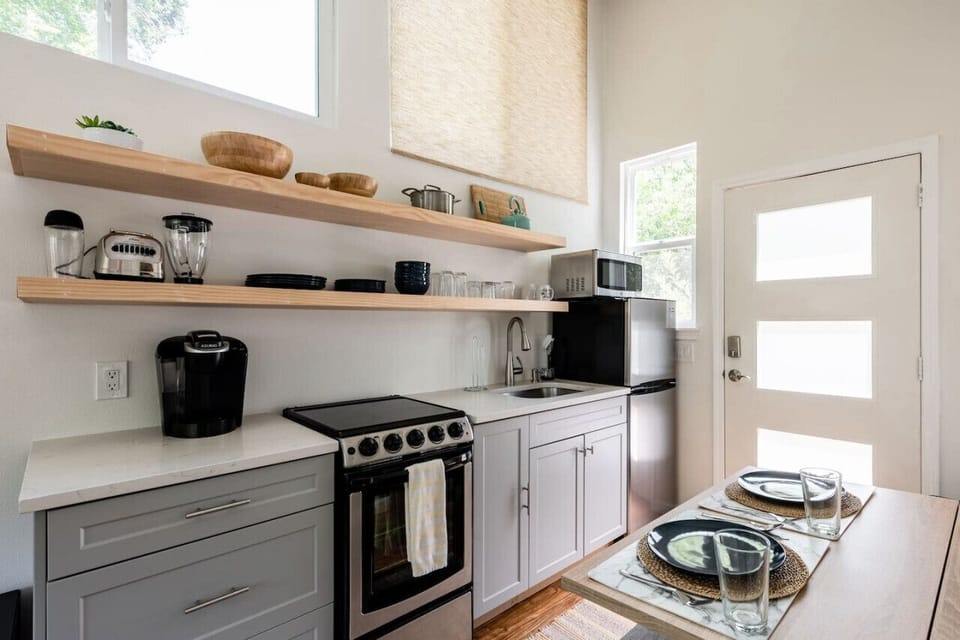 Full kitchen with a tiny oven for a tiny home; tea & coffee available (but top notch coffee shops within a short bike ride or 2-minute drive)