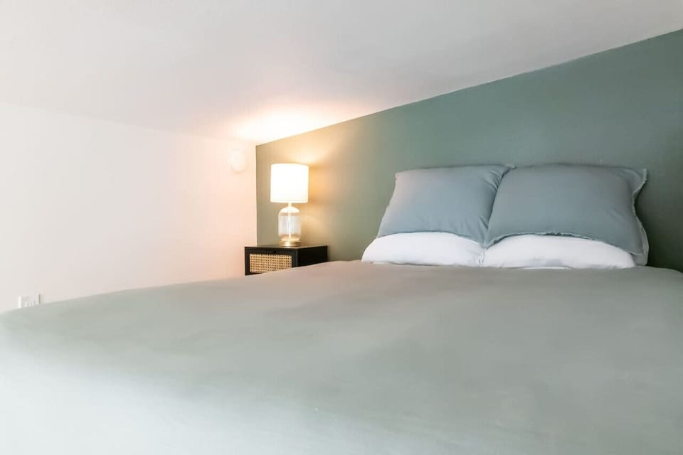 Queen bed with luxury linens in the spacious loft