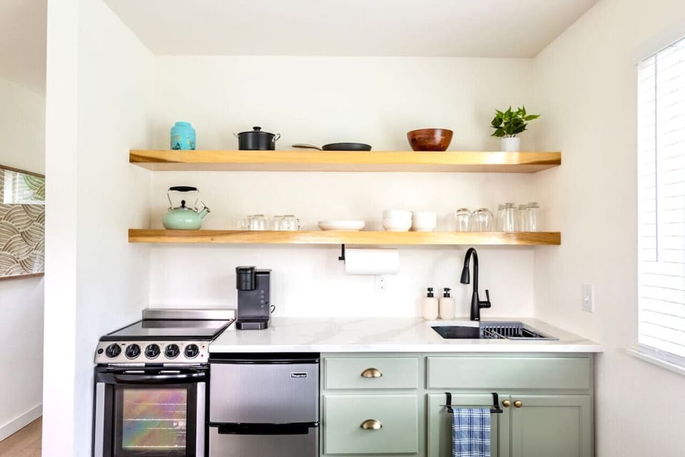 Full kitchen with an appropriate sized stove (tiny stove for tiny home!), includes all the cooking utensils for those more ambitious in the kitchen!