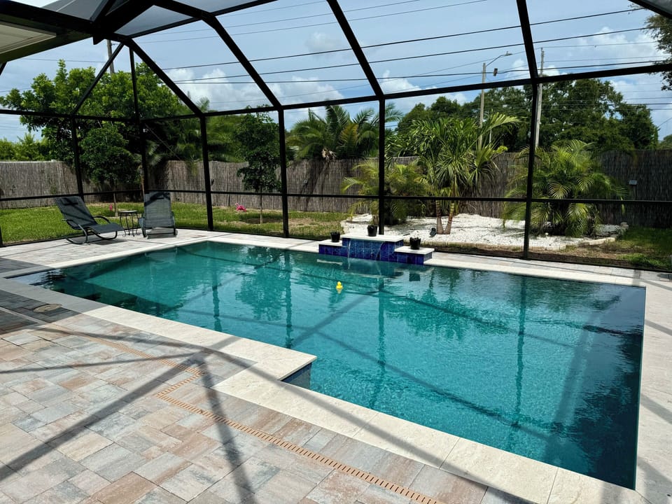 Your Own Private Oasis-New Custom Pool with Views of Tropical Landscaping & Yard