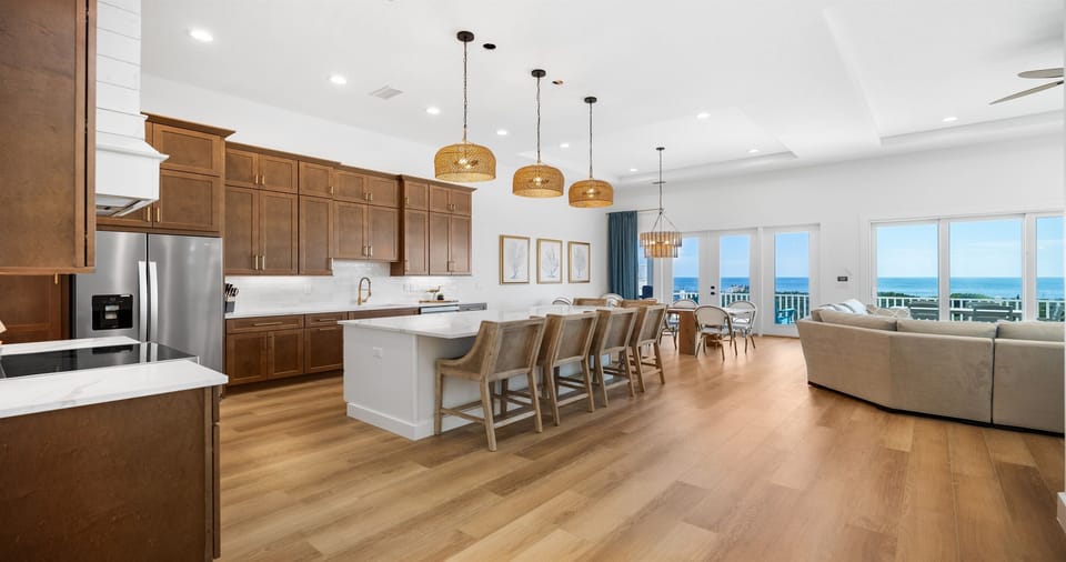Designed for gathering with ocean views 🌊
This open-concept kitchen and dining area offers ample seating, modern finishes, and stunning Atlantic views—ideal for group meals and memorable evenings together.
