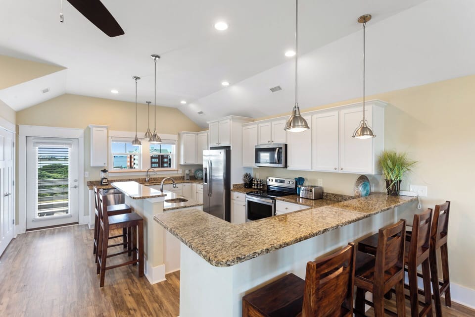 Whip up something delicious in the state-of-the-art Kitchen featuring elegant granite countertops and gleaming stainless steel appliances.