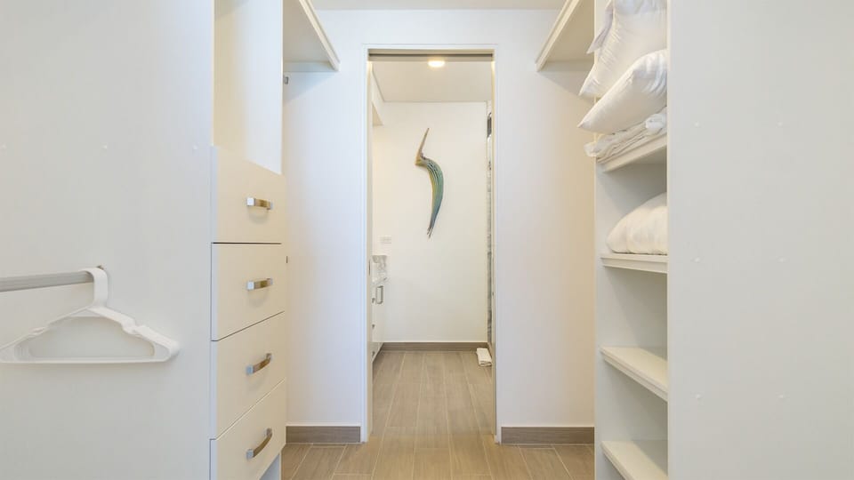 This huge walk in closet connects to the bathroom
