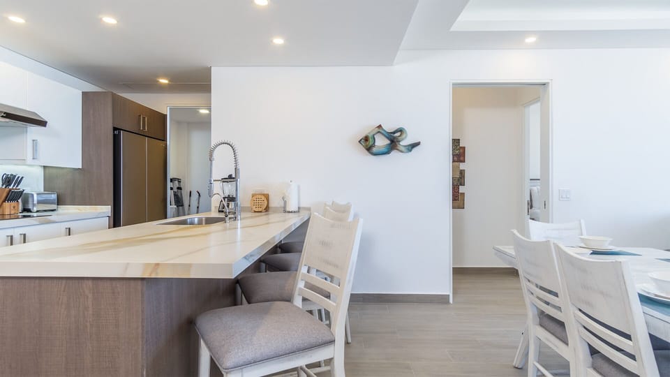The kitchen counter is next to the dining table, and provides additional seating