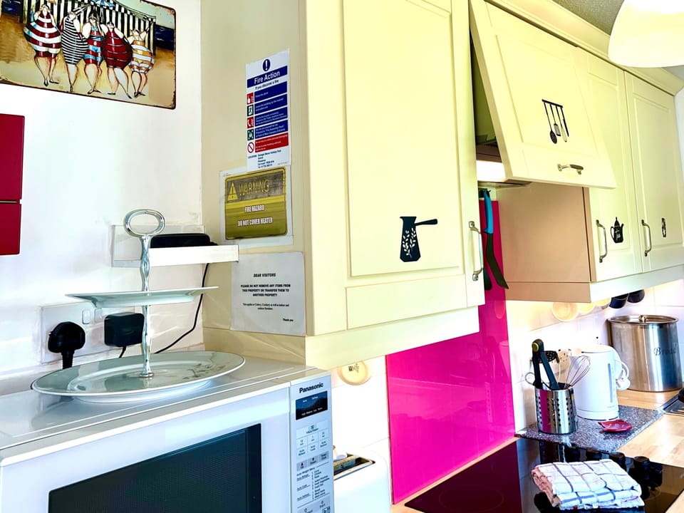 Kitchen. Microwave. Toaster. Kettle. Fridge freezer. Full size oven and four ring ceramic hob. Cutlery and crockery 