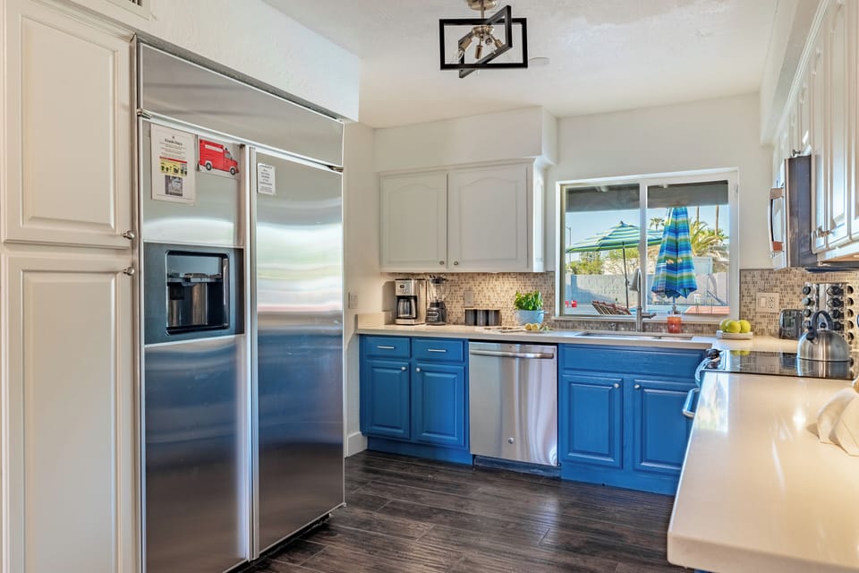 The kitchen offers modern amenities and a large fridge.