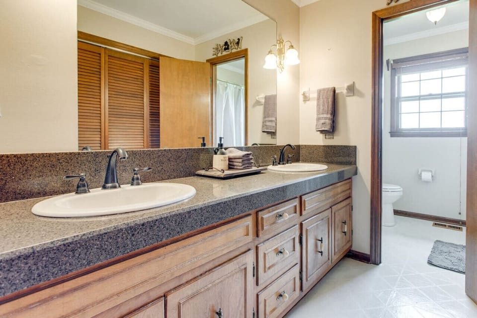 Full bathroom off of the hallway has two sinks and the toilet and shower have a door for added privacy.