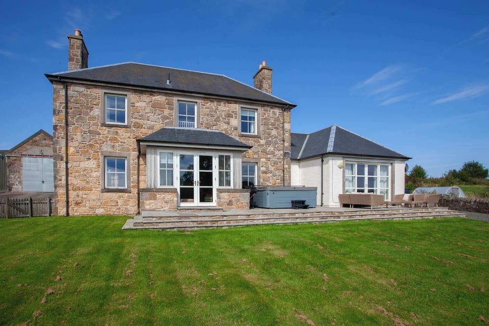 Garden area with hot tub and patio area.