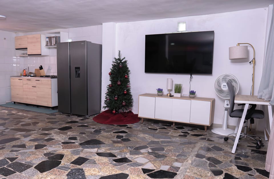 Open floor plan Living Room & Kitchen with work desk and 75" smart tv.