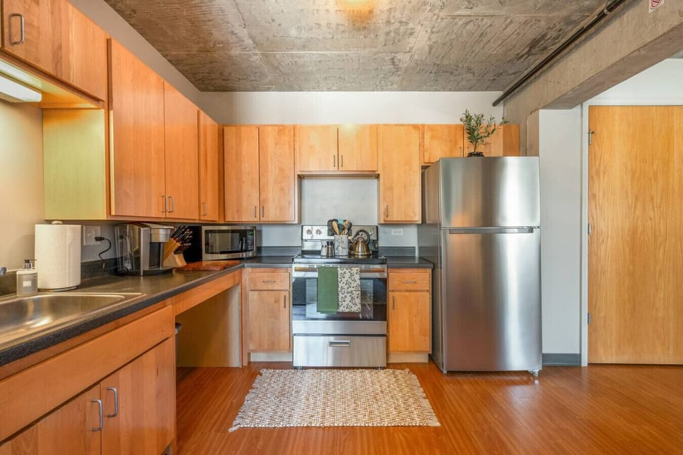 Fully equipped modern kitchen with stainless steel appliances and ample counter space.
