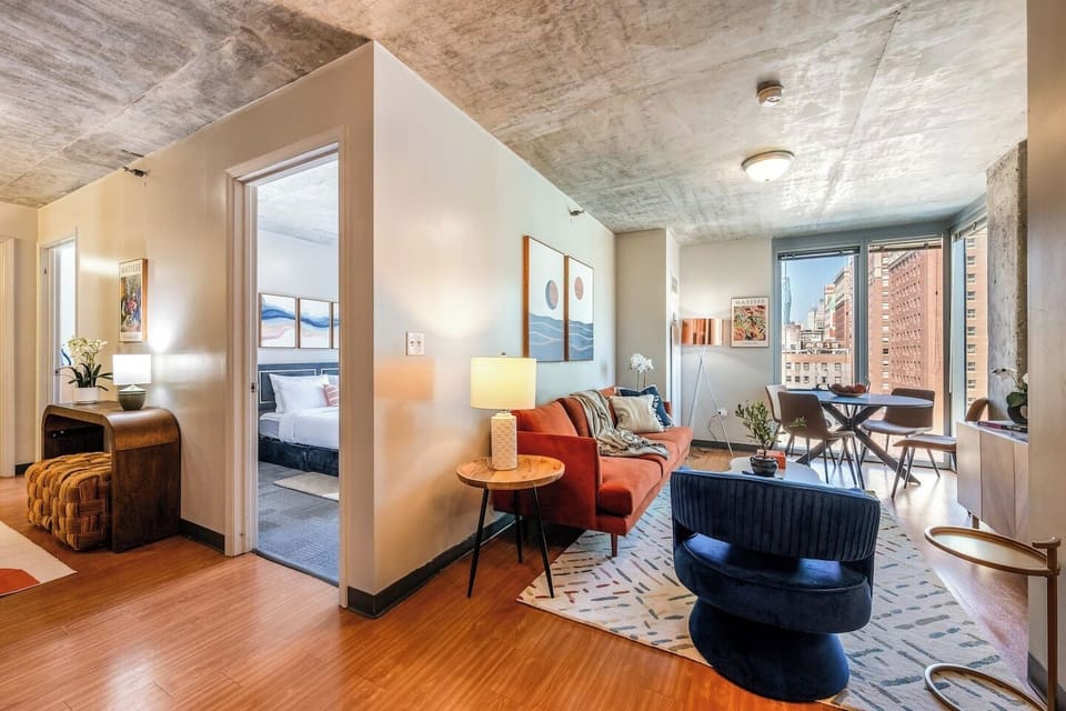 Bright, stylish apartment with a cozy living area, city views, and a peaceful bedroom retreat